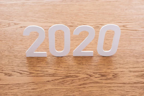 Paper white 2020 numbers on wooden brown background — Stock Photo