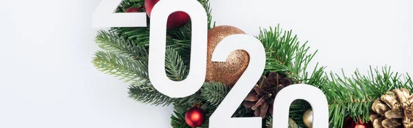 Top view of 2020 numbers on Christmas tree wreath on white background, panoramic shot — Stock Photo