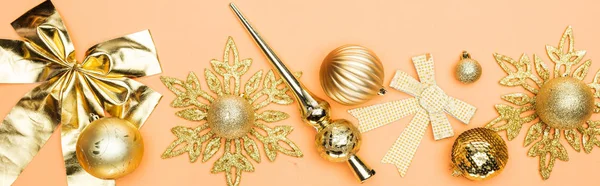 Top view of festive golden christmas decoration on orange background, panoramic shot — Stock Photo