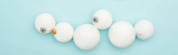 Top view of white Christmas baubles on light blue background, panoramic shot — Stock Photo