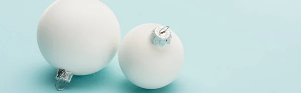 White Christmas baubles on light blue background with copy space, panoramic shot — Stock Photo