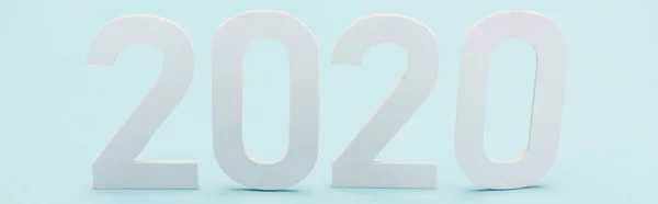 Panoramic shot of white 2020 numbers on light blue background — Stock Photo