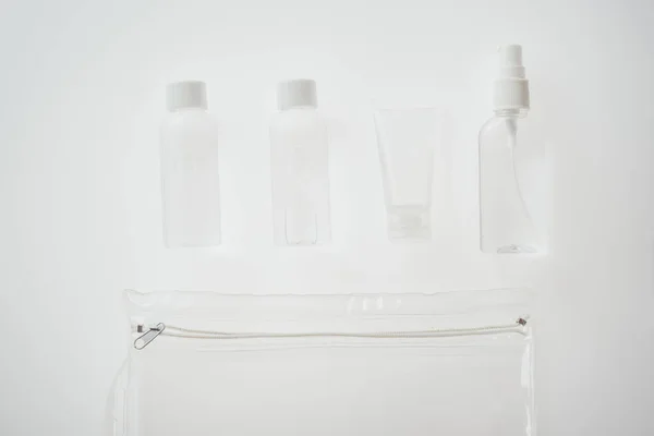 Top view of bottles and tube with liquids on white background — Stock Photo