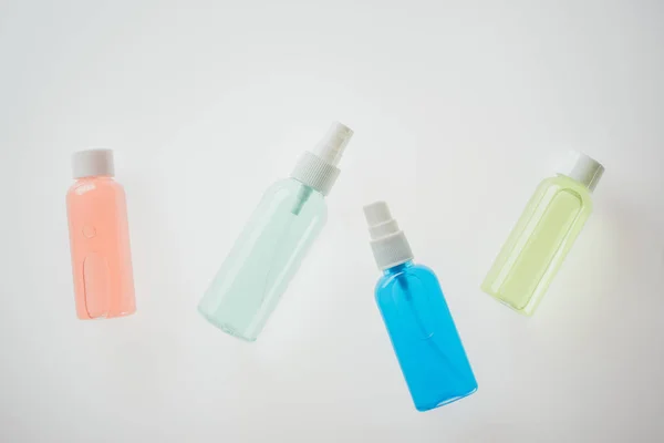 Top view of colorful bottles with liquids on white background — Stock Photo