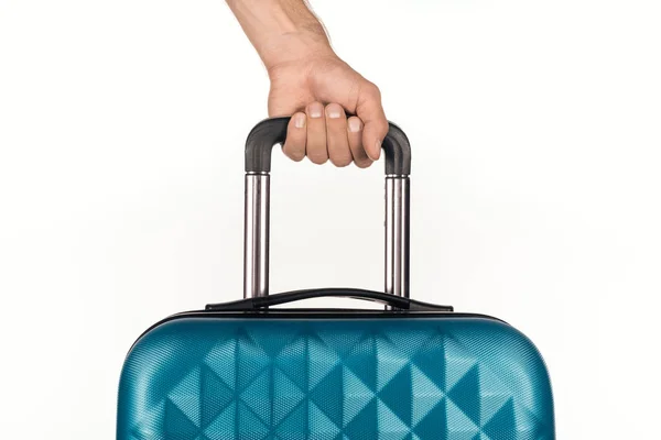 Cropped view of man holding travel bag with cosmetic bag with colorful bottles with liquids on white background — Stock Photo