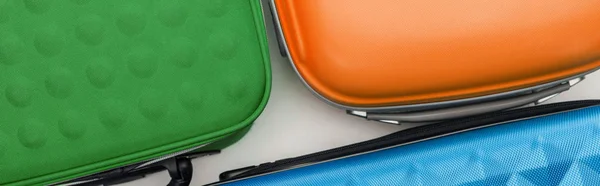 Panoramic shot of bright travel bags on white background — Stock Photo