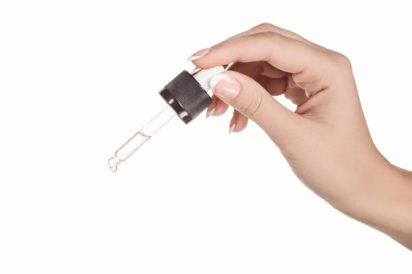 Cropped view of woman holding dropper with natural serum isolated on white — Stock Photo