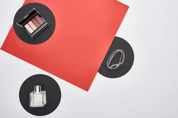 Top view of bracelets, eye shadow and perfume — Stock Photo