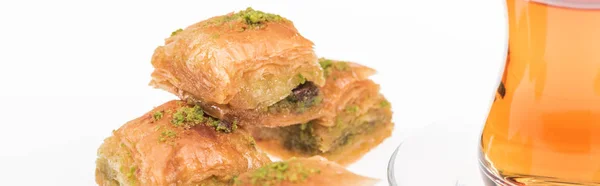 Delicious turkish baklava and tea isolated on white, panoramic shot — Stock Photo