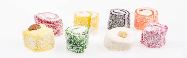 Assorted delicious turkish delight in coconut flakes isolated on white, panoramic shot — Stock Photo