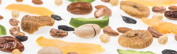 Close up view of tasty assorted nuts, dried fruits and candied fruit isolated on white, panoramic shot — Stock Photo