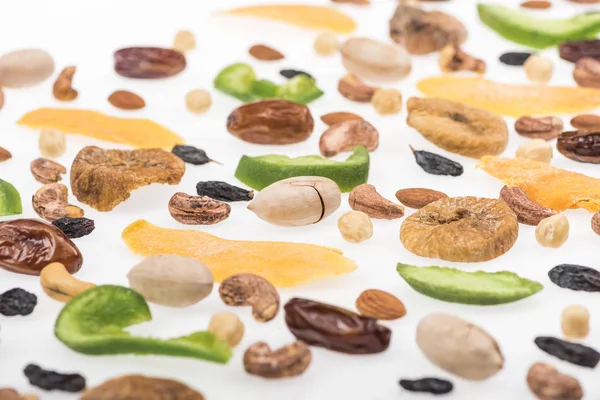 Close up view of tasty assorted nuts, dried fruits and candied fruit isolated on white — Stock Photo