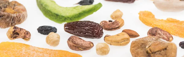 Close up view of tasty assorted nuts, dried fruits and candied fruit isolated on white, panoramic shot — Stock Photo