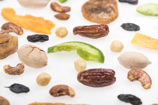 Close up view of tasty assorted nuts, dried fruits and candied fruit isolated on white — Stock Photo