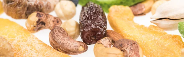 Close up view of Turkish assorted nuts, dried fruits and candied fruit isolated on white, panoramic shot — Stock Photo