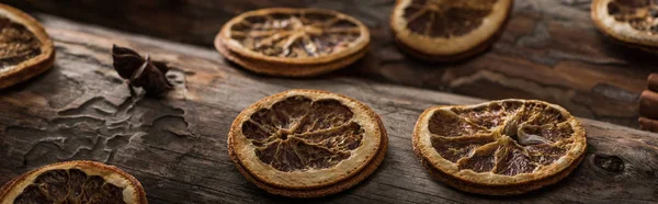 Dried citrus slices with anise on wooden background, panoramic shot — Stock Photo