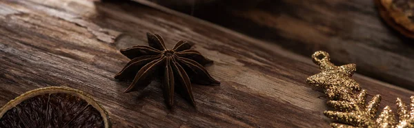 Dried citrus slice with anise and decorative snowflake on wooden background, panoramic shot — Stock Photo