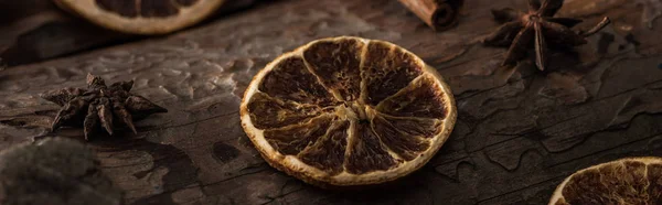 Dried citrus slices with anise on wooden background, panoramic shot — Stock Photo