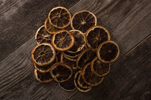 Top view of dried citrus slices on wooden brown surface — Stock Photo