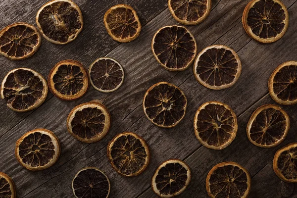 Top view of dried citrus slices on wooden brown surface — Stock Photo