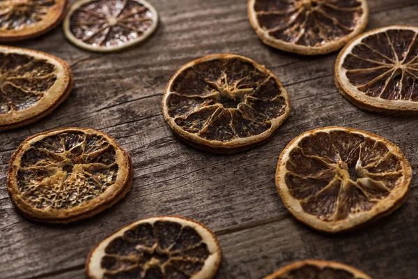 Dried citrus slices on wooden brown surface — Stock Photo