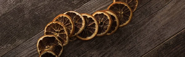 Top view of dried orange slices on wooden background, panoramic shot — Stock Photo