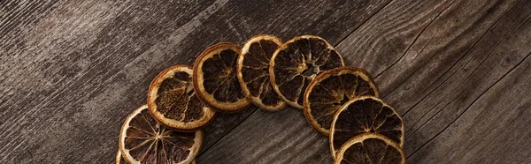 Top view of dried orange slices on wooden background, panoramic shot — Stock Photo