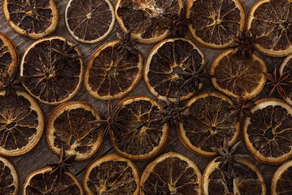 Vista superior de fatias de laranja secas no fundo de madeira com anis — Fotografia de Stock