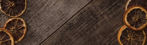 Top view of dried orange slices on wooden background with copy space, panoramic shot — Stock Photo