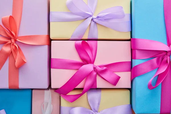 Flat lay with multicolored gift boxes with ribbons and bows — Stock Photo