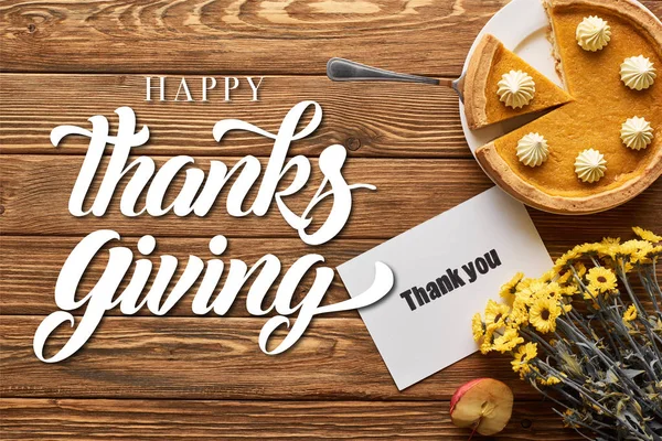 Top view of tasty pumpkin pie, apples and thank you card on wooden rustic table with flowers and happy thanksgiving illustration — Stock Photo