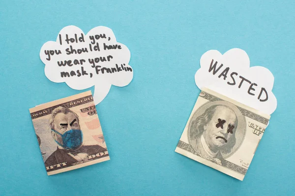 Top view of dollar banknotes with drawn medical mask and speech bubbles on blue background — Stock Photo