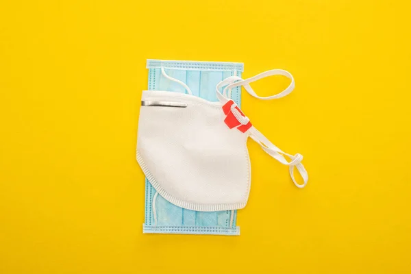 Top view of medical and safety masks on yellow background — Stock Photo