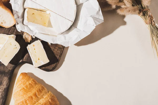 Top view of of french breakfast with croissant, Camembert on wooden cutting board on white tablecloth — Stock Photo