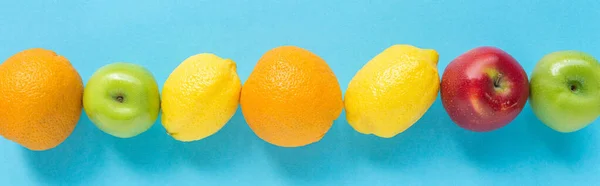 Top view of ripe fruits on blue background, panoramic shot — Stock Photo