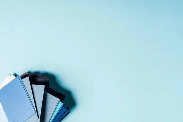 Top view of color swatches on blue background with copy space — Stock Photo