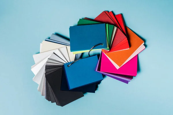 Top view of colorful swatches on blue background — Stock Photo