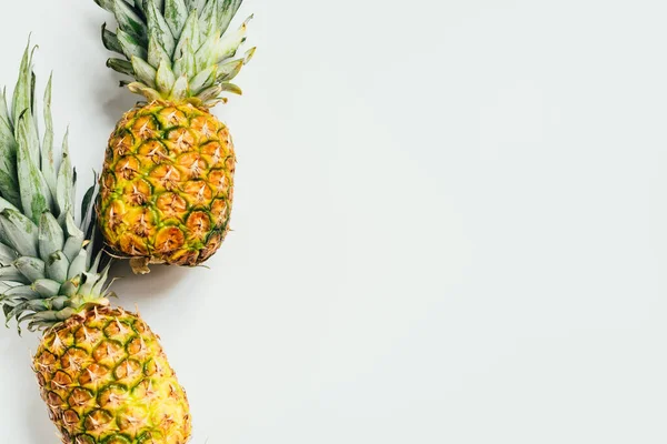 Top view of fresh ripe pineapples on white background — Stock Photo