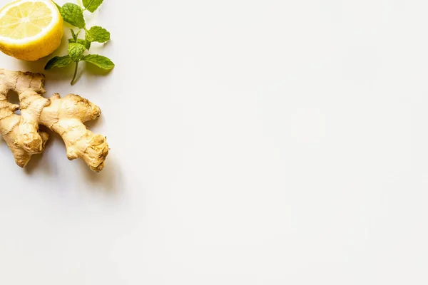 Top view of ginger root, lemon and mint on white background — Stock Photo