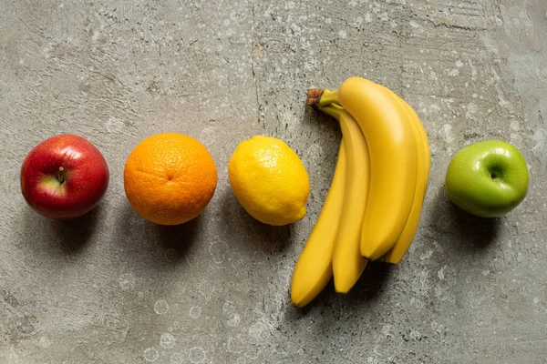 Top view of tasty colorful fruits on grey concrete surface — Stock Photo