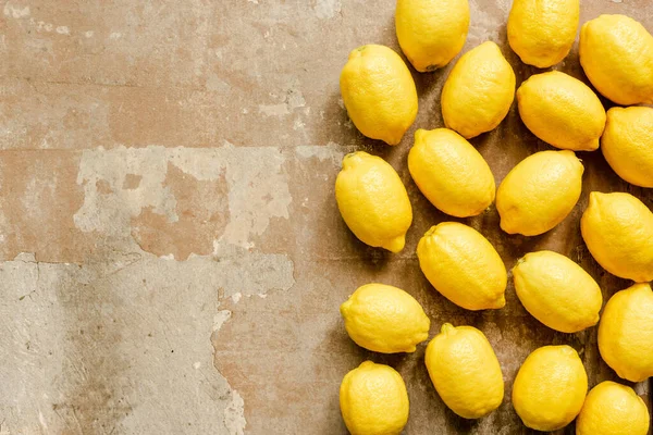 Vue de dessus des citrons jaunes mûrs sur la surface altérée — Photo de stock