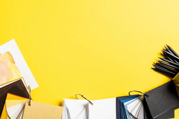 Top view of painting and blank samples near color pencils isolated on yellow — Stock Photo