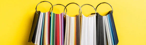 Panoramic shot of colorful samples set on yellow — Stock Photo