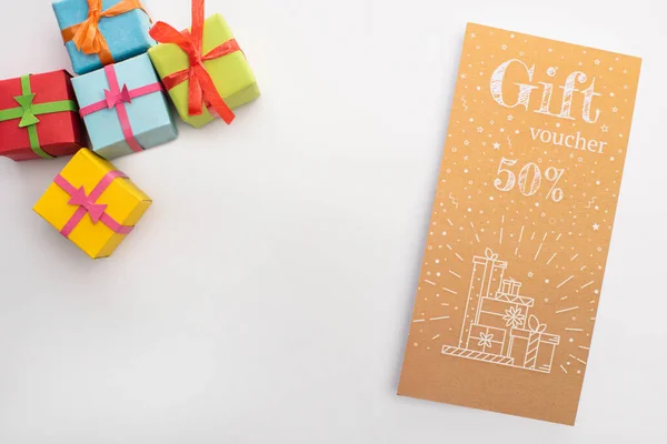 Top-Ansicht von Geschenken und Gutscheinen mit 50 Prozent Zeichen auf weißem Hintergrund — Stockfoto