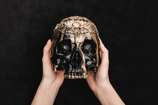 Top view of witch holding voodoo skull on black — Stock Photo