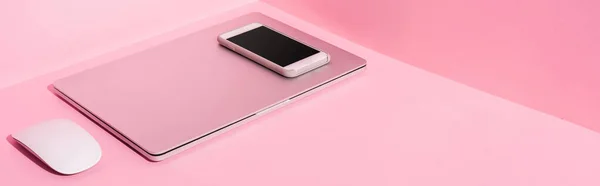 Laptop, smartphone and computer mouse on pink background, panoramic shot — Stock Photo