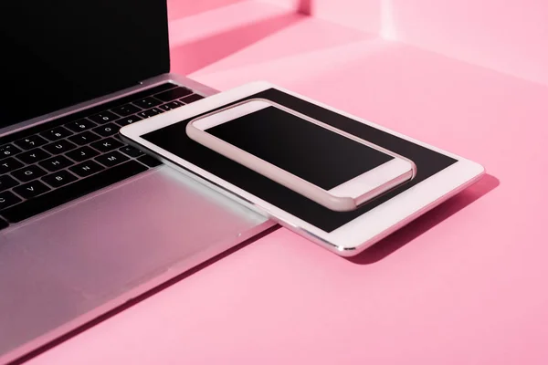 Modern gadgets with blank screens on pink background — Stock Photo