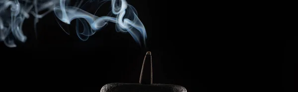 Burning incense on stone with smoke on black background, panoramic shot — Stock Photo