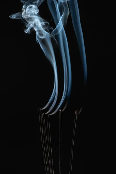 Burning aroma sticks with smoke on black background — Stock Photo