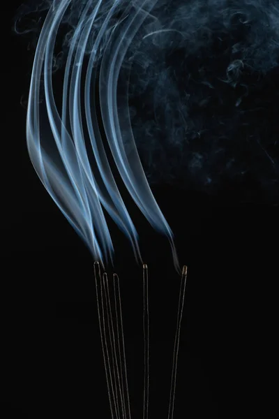 Burning aroma sticks with smoke on black background — Stock Photo